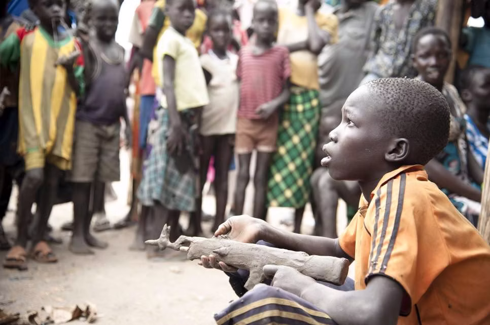 Young South Sudanese boy with mud gun